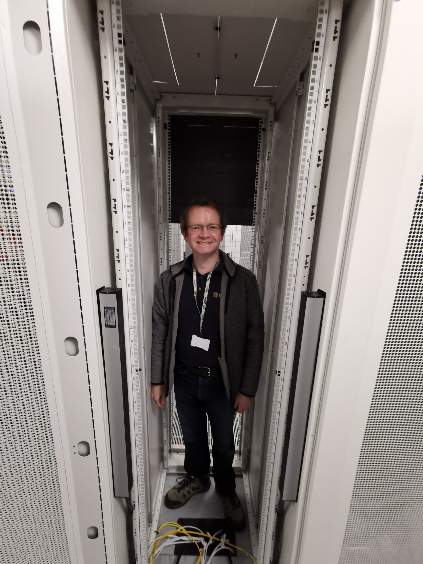 Jason Timmins, our Technical Director, stand in the rack that used to house our hosting facility. At his feet are five 1,000Mbit/s Internet connections.